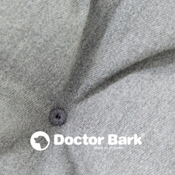 Graues Haustierbett mit gepolstertem Design, beschriftet 'Doctor Bark', mit Text über Haltbarkeit, Hygiene, Waschbarkeit und Allergietauglichkeit.