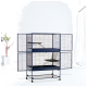Großer blauer mehrstöckiger Haustierkäfig mit Drahtgitter, zwei Regalen und offenen Türen, vor einem hellen, minimalistischen Hintergrund.