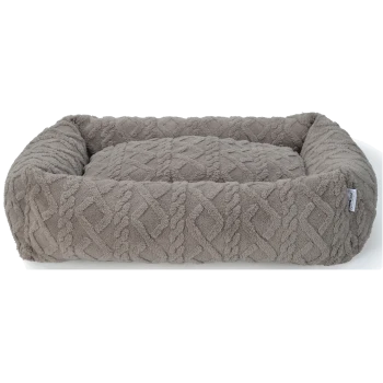Un lit pour animaux de compagnie en peluche gris avec un motif en diamant texturé et des bords surélevés, conçu pour le confort et le soutien.