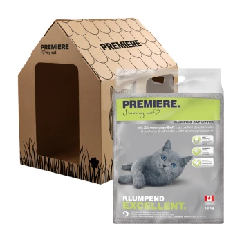 Ein Pappkatzenhaus mit der Aufschrift "PREMIERE Ich liebe meine Katze" neben einem 12 kg Sack katzenstreu mit Zitronengrasduft und einer grauen Katze darauf.