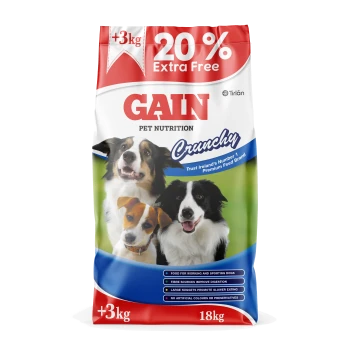 Bag of GAIN pet nutrition Crunchy dog food (18kg) with three dogs pictured; 20% Extra Free, +3kg visible.