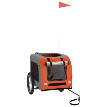 Tieranhänger in Grau und Orange mit einem Netzfenster, zwei Rädern und einer Sicherheitsflagge, entworfen für den Transport von Haustieren.