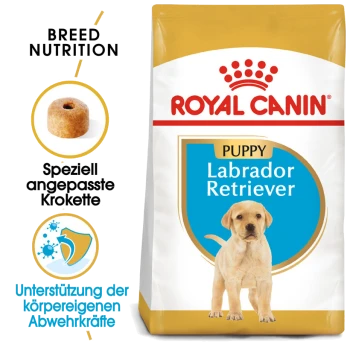 Royal Canin Labrador Retriever Welpenfutterbeutel mit einem gelb-weißen Design, mit Text, der die Rassenernährung und die Unterstützung des Immunsystems hervorhebt.