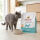 Grey cat beside empty bowl and bag of Select Gold Medica Veterinary Diet hypoallergenic cat food (2.5 kg) in kitchen