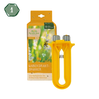 Gelbes Wachsdraht-Spannwerkzeug, das vor einer bunten Verpackung mit Blumen und einer Biene präsentiert wird, beschriftet mit "WABENDRAHT-SPANNER."