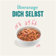 Schüssel mit Haustierfutter, gefüllt mit Hackfleisch und Gemüse, mit dem Text "Überzeuge DICH SELBST" darüber.