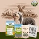 Ein Bearded Collie steht neben Bellfor-Hundefutterprodukten mit einer Windmühle und ländlicher Kulisse im Hintergrund.