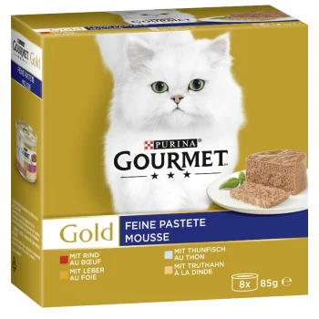 Die Verpackung des Purina Gourmet Gold Katzenfutters zeigt eine flauschige weiße Katze und Mousse auf einem Teller, mit aufgelisteten Geschmacksrichtungen: Rind, Thunfisch, Pute und Leber.