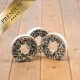 Drei Premium-Vogelfutter-Donuts mit einer weißen Basis und einer Füllung aus schwarzen Sonnenblumenkernen, auf einer Holzoberfläche präsentiert.