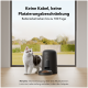 Eine Katze steht neben einem schwarzen automatischen Futterspender auf Holzboden, mit Trockenfutter davor. Der Text erwähnt eine Batterielebensdauer von 180 Tagen.
