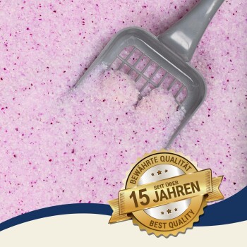 Eine graue Katzenstreuschaufel liegt auf rosa Katzenstreu mit lila Sprenkeln, mit einem Abzeichen, das "Beste Qualität - 15 Jahre" (15 Jahre) liest.