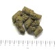 Grün-braune, zylindrische Tierfutterpellets auf weißem Hintergrund über einem Lineal mit cm-Markierung (das 'cm'-Etikett ist sichtbar).