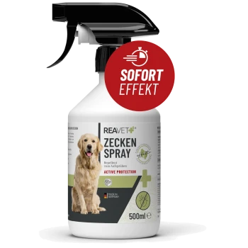 Eine 500ml Zeckenabwehrsprayflasche mit der Aufschrift "REAVET+ ZECKEN SPRAY", mit Hundillustration und rotem Etikett "SOFORT EFFEKT." Hergestellt in Deutschland.