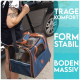 Eine Person hält eine blaue Haustiertragetasche mit orangefarbenen Akzenten und Netzpaneelen, beschriftet mit "TRAGE KOMFORT," "FORM STABIL," und "BODEN MASSIV."