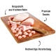 Frische Hühnerstücke und Snacks auf einem Holzbrett, mit Text: "Premium Snacks," "Hergestellt aus frischem Huhn," und "Hochwertige Verarbeitung."