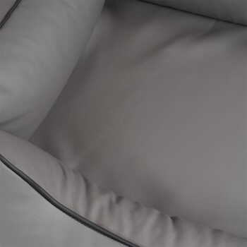 Nahaufnahme eines weichen, grauen Haustierbettes mit plüschiger Polsterung und schwarzem Rand, entworfen für den Komfort von Haustieren.