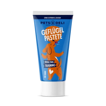 Blauer Tubus mit Hundepaste, beschriftet mit "Geflügel Pastete," mit einer verspielten Hundegrafik und Text, der "Ideal fürs Training" und "Für Hunde" angibt.