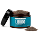 Ein braunes Päckchen mit der Aufschrift 'Libido Balance Pulver' mit grünen und blauen Akzenten, das 'Unterstützt ein ausgewogenes Verhalten' für Hunde angibt, 100 Gramm.