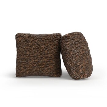 Zwei Stücke strukturiertes braunes Trockenhundefutter auf weißem Hintergrund.