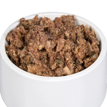 Eine Nahaufnahme einer weißen Haustierfutterschüssel, gefüllt mit einer groben, braunen Fleischmischung, die feuchtem Hunde- oder Katzenfutter ähnelt.