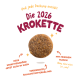 Runde braune Krokettenkugel auf beigem Hintergrund mit deutschem Text 'Die 2026 KROKETTE' und 'Mit frischem Fleisch'.