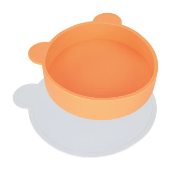 Bol de nourriture pour animaux de compagnie orange avec des oreilles d'ours, placé sur un tapis en forme de patte blanche.