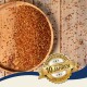 Eine Holzschüssel gefüllt mit bunten Samen, mit einigen verstreut auf einer Holzoberfläche. Ein Abzeichen liest "Beste Qualität" und "10 Jahre" auf Deutsch.