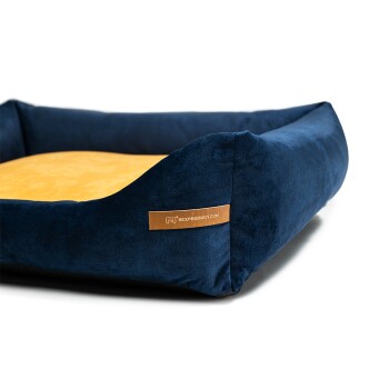 Navyblaues Haustierbett mit einem weichen gelben Innenraum und einem braunen Etikett mit der Aufschrift "RexProduct.com" an der Seite.