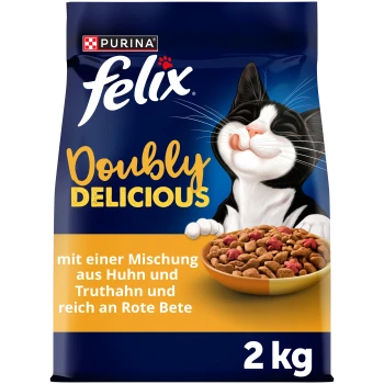 Purina Felix "Doppelt Lecker" 2 kg Katzenfutterbeutel, Tuxedo-Katze neben einer Schale mit Kroketten, deutscher Text über Huhn, Truthahn und Rote Bete