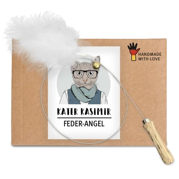 Eine Pappverpackung mit einer verspielten Katzenillustration und dem Text 'KATER KASIMIR FEDER-ANGEL' sowie einem angehängten Feder-Spielzeug.
