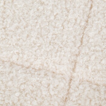 Close-up of a soft, fluffy white pet blanket with a textured, curly surface.