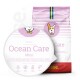 Hundefutterbeutel mit der Aufschrift "Ocean Care Mini" in Pink, mit einem Hundesymbol und Hervorhebung von Präbiotika, glutenfrei und Lachs.