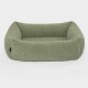 Grünes, plüschiges Haustierbett mit erhöhten Rändern, entworfen für Komfort und Unterstützung, auf einem weißen Hintergrund präsentiert.