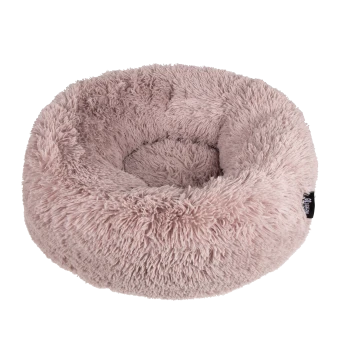 Fluffiges, rundes Haustierbett in sanftem Rosa, mit einer plüschigen Textur und einem kleinen Etikett an der Seite.