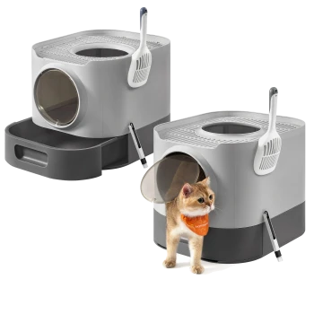 Moderne graue und schwarze Katzentoilette mit Deckel, Schaufel, Bürste und einer Katze mit orangefarbener Bandana, die die Toilette verlässt.