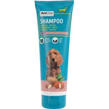 Tube de shampooing AniOne pour chiot, bleu, grand texte 'SHAMPOO', photo de chiot, image d'amande et étiquettes 'PUPPY', 'Almond oil', 'Vegan'.