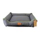Gray pet bed with green trim and a leather tag labeled "Beddies." The bed features raised sides and a soft cushion.