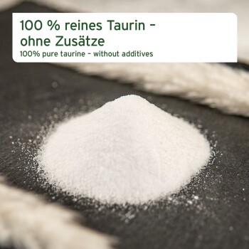 Haufen weißen Taurinpulvers auf dunkler Oberfläche mit Banner: '100% reines Taurin – ohne Zusatzstoffe'.