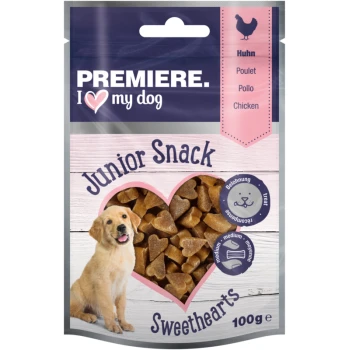 Emballage de friandises pour chiens avec 'Première. J ❤️ mon chien' avec un chiot golden retriever, des collations en forme de cœur et l'étiquette 'Junior Snack Sweethearts'.