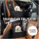 Ein kleiner weißer Hund sitzt in einem schwarzen Autositz für Haustiere in einem Luxusfahrzeug. Der Text lautet: "POLEPOSITION FÜR PFOTEN" und "FÜR VORDER- & RÜCKSITZ."