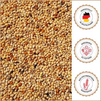 Nahaufnahme von gemischtem Vogelfutter mit drei Abzeichen: "Made in Germany", "Ganzjährig füttern" und "Aus hochwertigen Rohstoffen" auf Deutsch.