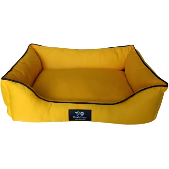 Yellow pet bed with raised edges and black trim, featuring a label that reads "Beddies Made in Ireland."