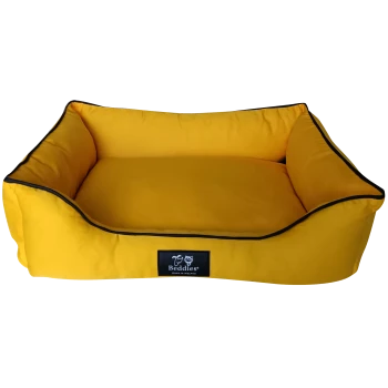 Yellow pet bed with raised edges and black trim, featuring a label that reads "Beddies Made in Ireland."