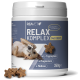 Weißes Glas mit der Aufschrift 'REAVET RELAX KOMPLEX 140 DROPS 350g' mit braunen sternförmigen Leckerlis und +L‑Tryptophan +Magnesium +Melisse
