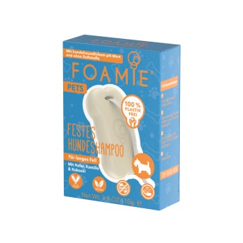Niebieskie pudełko stałego szamponu dla psów oznaczone "FOAMIE PETS," z niemieckim tekstem o równowadze pH, owsa, rumianku i certyfikacji wegańskiej.