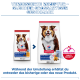 Zwei Hill's Science Plan Mature Adult 7+ Hundefutterbeutel (alt vs. neu) mit lächelndem Hund, 'VERBESSERTE REZEPTUR' und ActivBiome+.