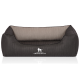 Ein stilvolles Hundebett in Dunkelgrau mit einem plüschigen, hellgrauen Innenraum, mit dem Logo "KNUFFELWUFF" auf der Vorderseite.