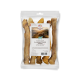 Pięć naturalnych kości jagnięcych dla psów, na tle owiec. Tekst: "Naturbelassene Lammpfüsse" i "100% Lamm - Single Protein."