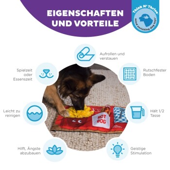 Ein Hund spielt mit einer bunten 'HOT DOG' Fütterungsmatte, die einfache Reinigung, rutschfeste Basis und Vorteile für die geistige Stimulation zeigt.