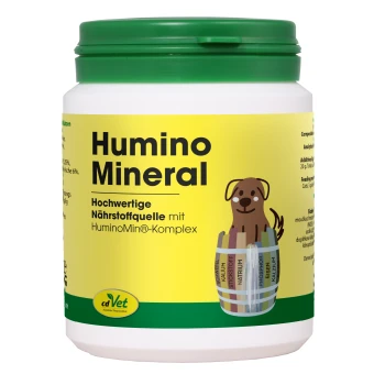 Weißer Behälter mit 'Humino Mineral' Haustierergänzungsmittel mit grünem Deckel, mit einem Cartoonhund und Nährwertinformationen auf Deutsch.